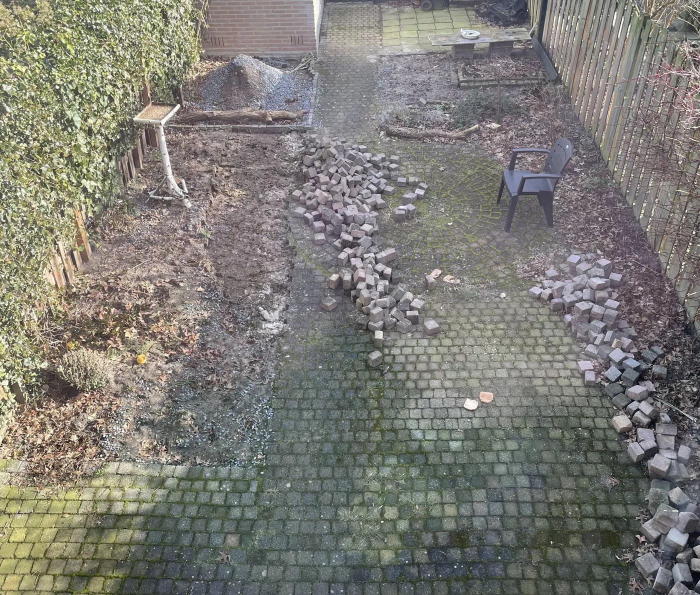 De achtertuin nu: losse stenen en kale grond